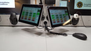 Two operator screens inside the vehicle