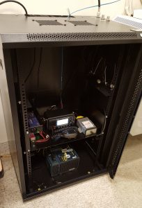 Rack shelf with radio and interface inside a cabinet